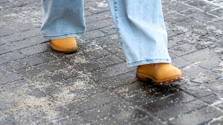person walks over area treated with salt
