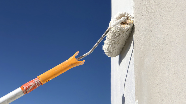 Paint roller on a white wall