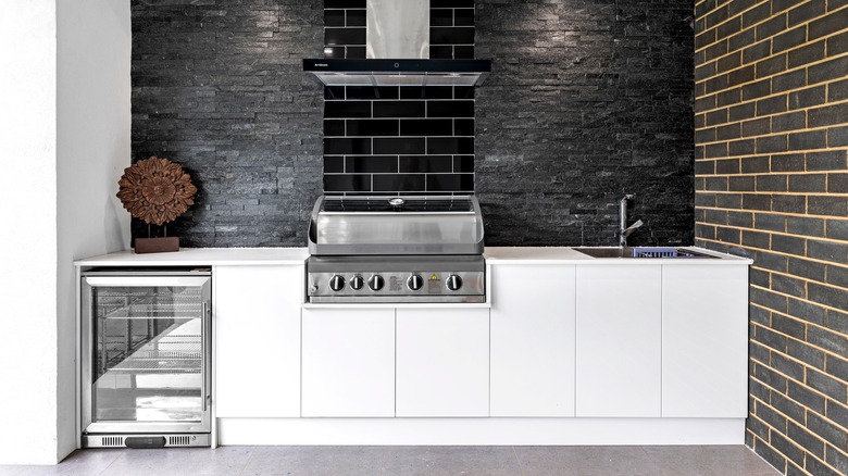 An outdoor kitchen complete with built-in fridge