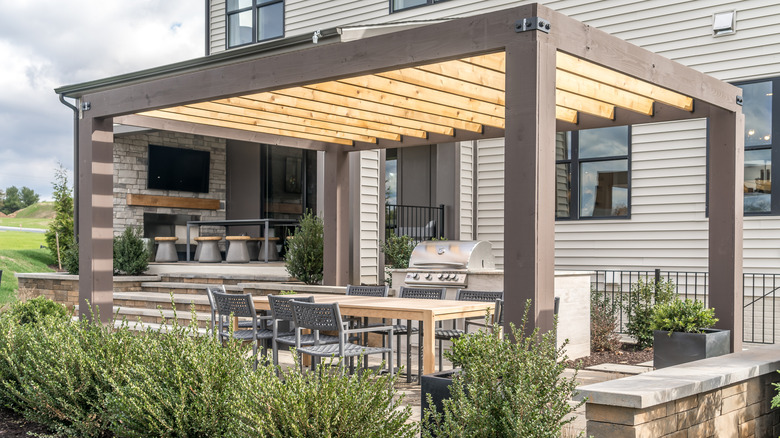 An outdoor kitchen beneath a pergola