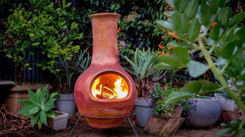 A beautiful clay chiminea with fire burning