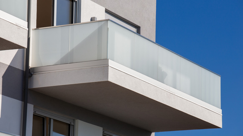 A modern balcony with frosted glass railings