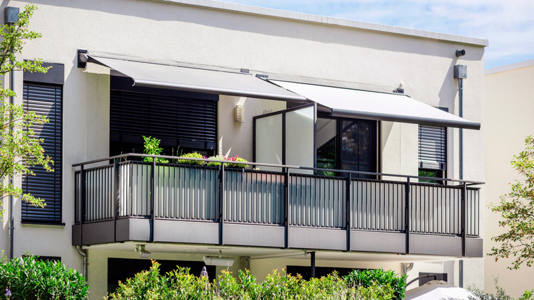A modern balcony with awnings and frosted glass balustrades
