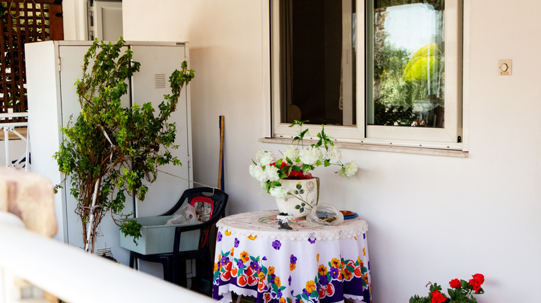 Small balcony with cabinet used as privacy screen