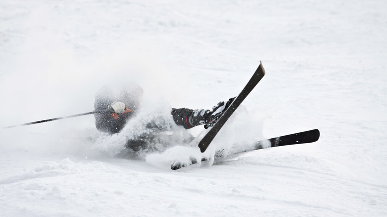 Skier falling down and crashing in the snow