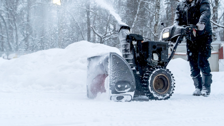 Person using snow blower