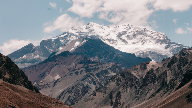 A mountain landscape with Aconcagua in the distance