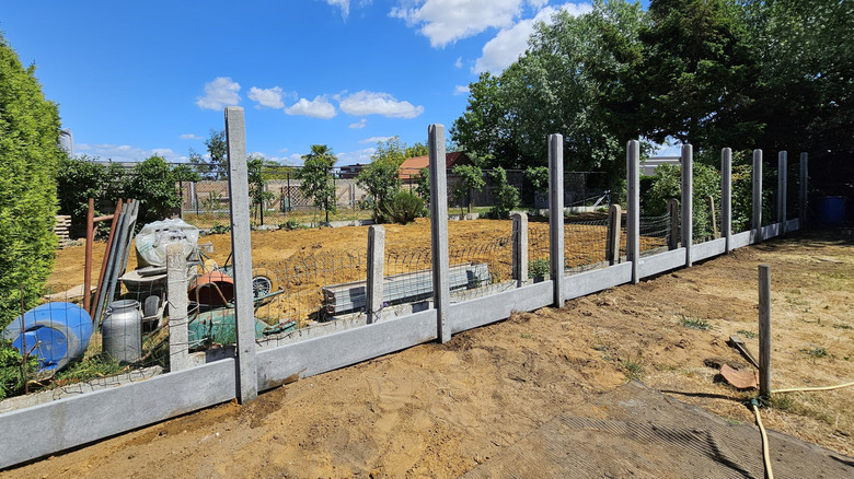 A fence in construction between neighboring properties
