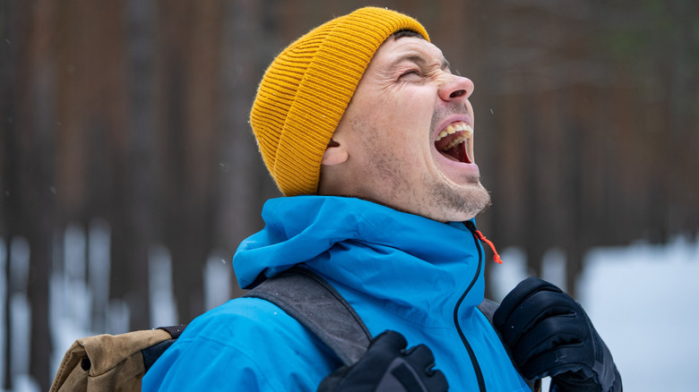 Person hiking and calling for help in the woods