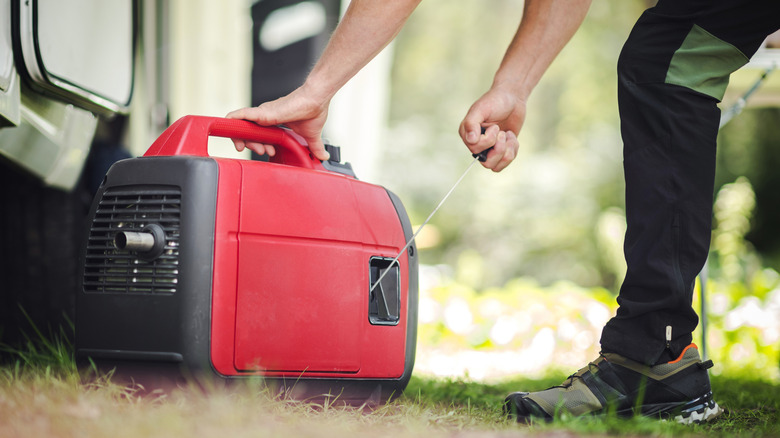 Man starting portable generator