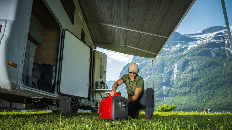 Man preparing to hook up generator to camper