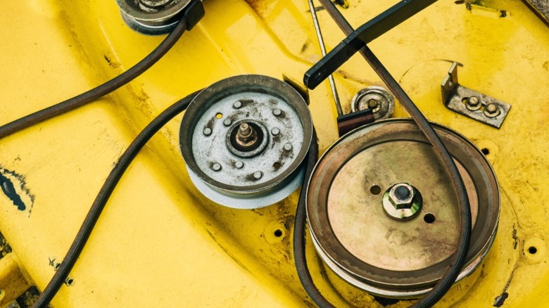 A mower deck with a belt being replaced