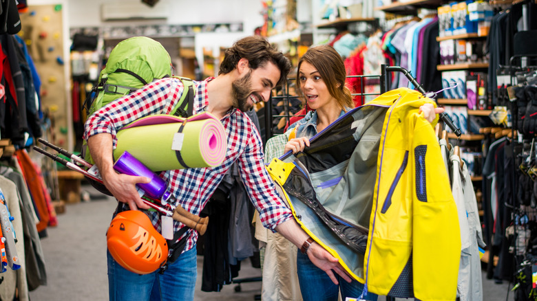 A man and a woman browsing outdoor gear in a store