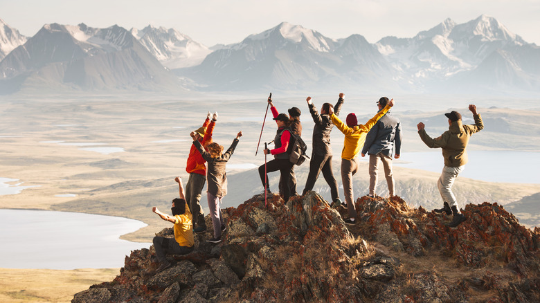 A large group of hikers enjoying themselves on a high summit