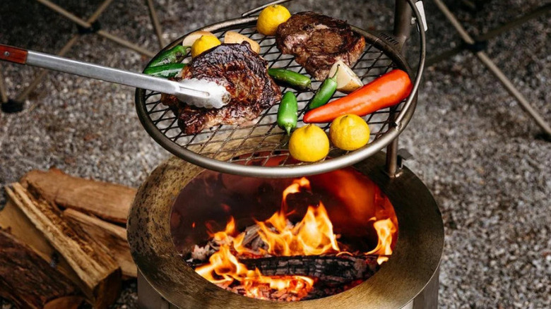 Food being cooked over the Breeo Y Series fire pit