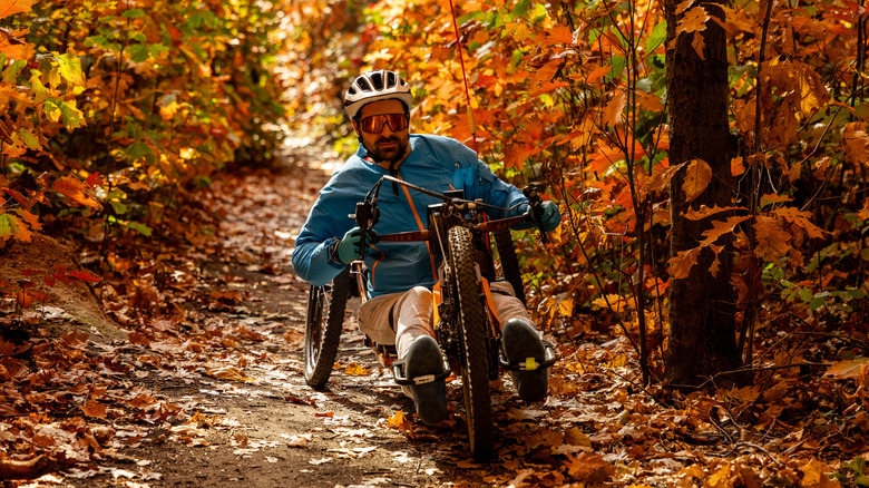 Adaptive mountain biker on a fall trail