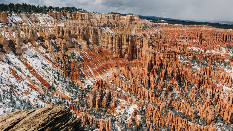 Natural red rock formations capped with snow at Arches National Park