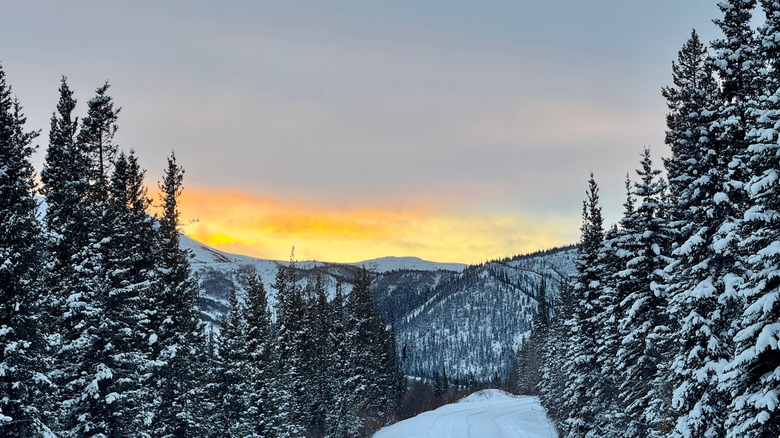 Sun setting behind snowy mountains at Denali National Park
