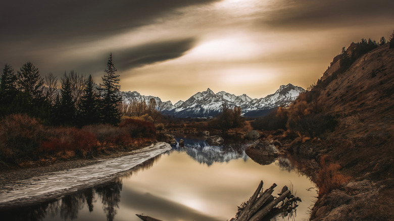 Wintry mountains reflected in a river at Yellowstone National Park