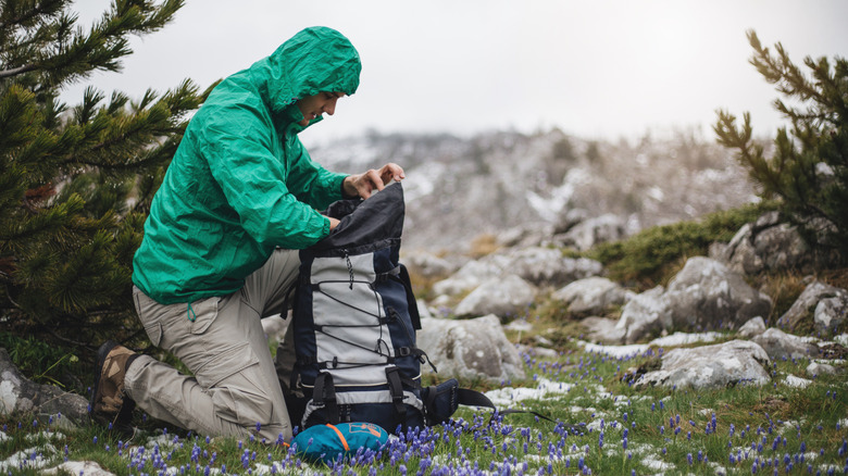 Hiker searching through backpack