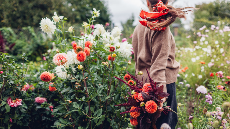 Woman in autumn garden, holding a bouquet