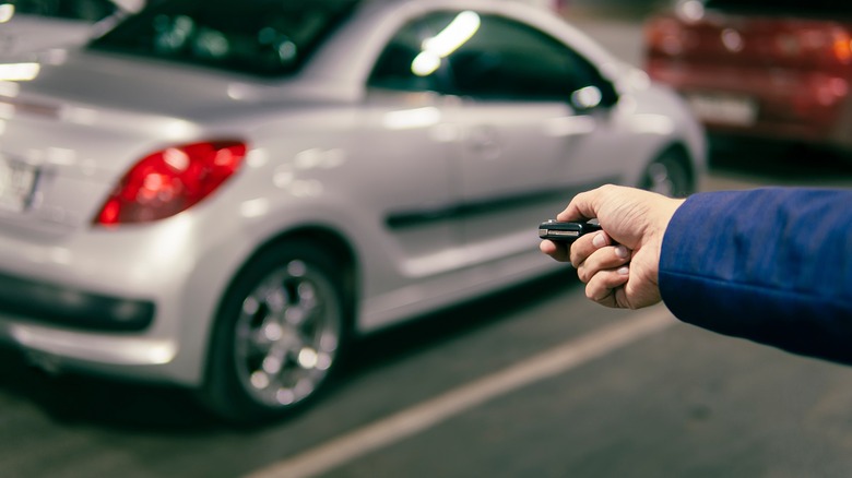 Man using key fob to unlock car