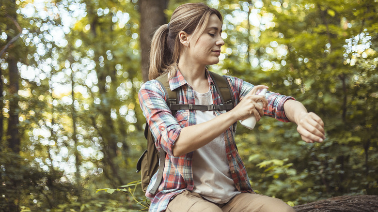 Woman applying mosquito repellent