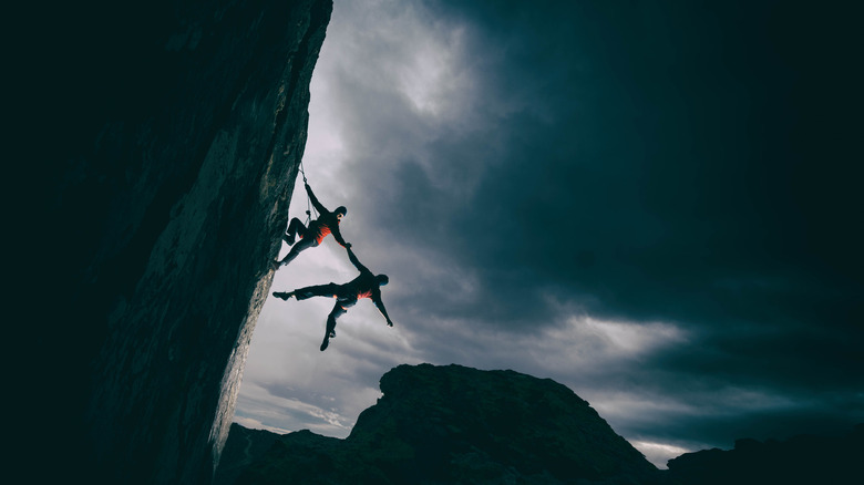 Two climbers hanging from a cliff