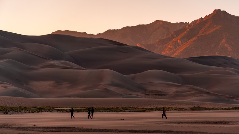 People walking in front of Great Sand Dunes