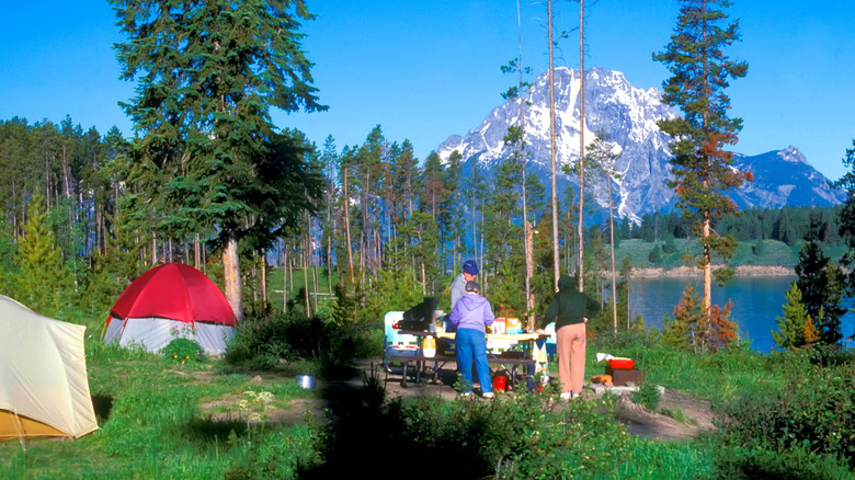 People at campsite with picnic table
