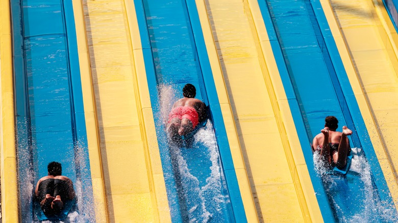 Young men on a large waterslide