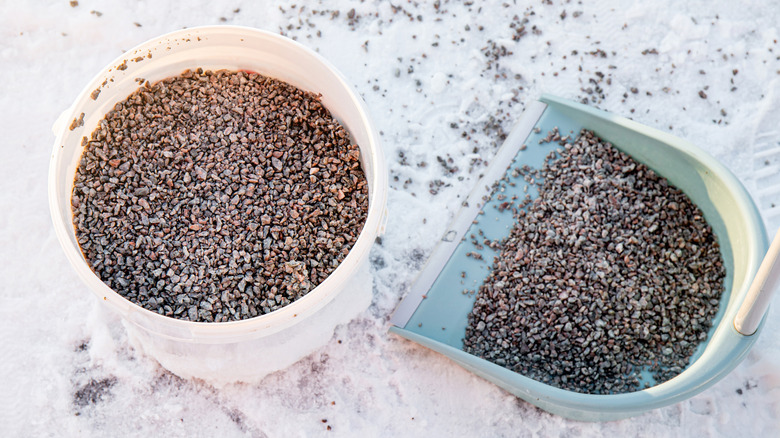 Bucket of gravel ready to spread on icy driveway