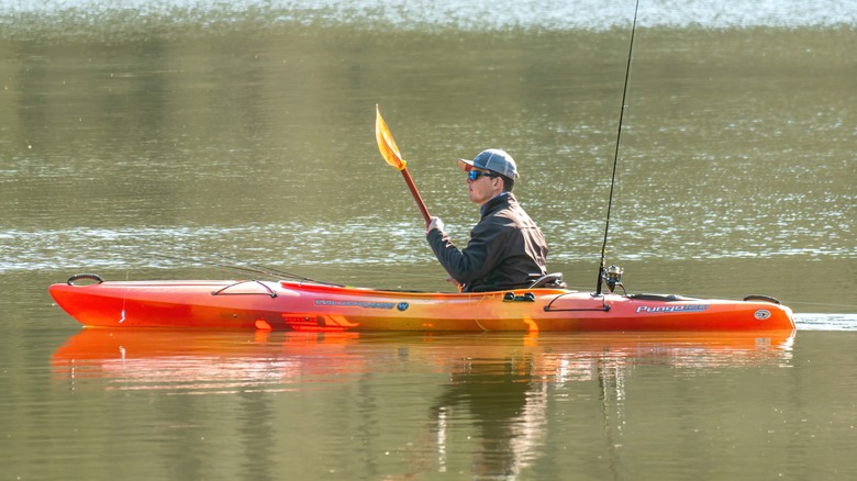 man kayaking with fishing pole on kayak in North Carolina