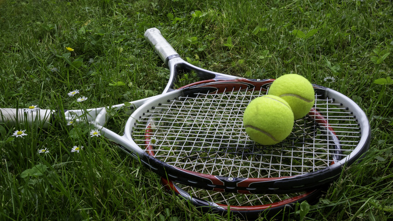 Two tennis rackets lying in grass