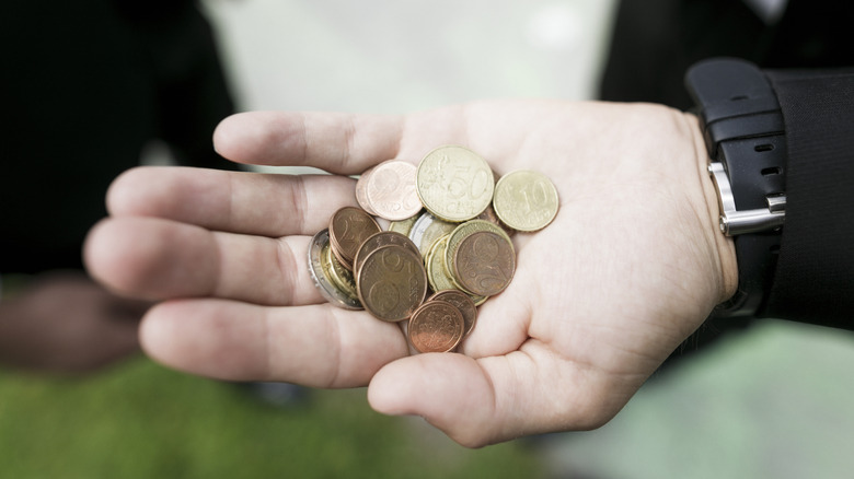 Person holding copper coins