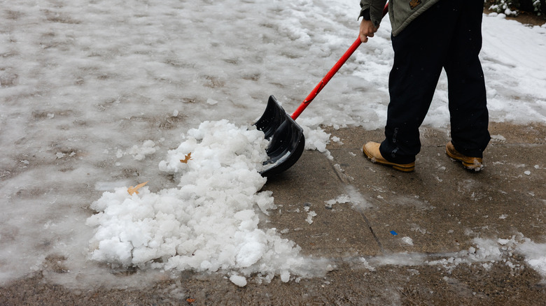 Clearing snow and ice on driveway