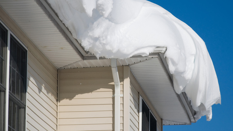 Deep snow hangs down from a roof