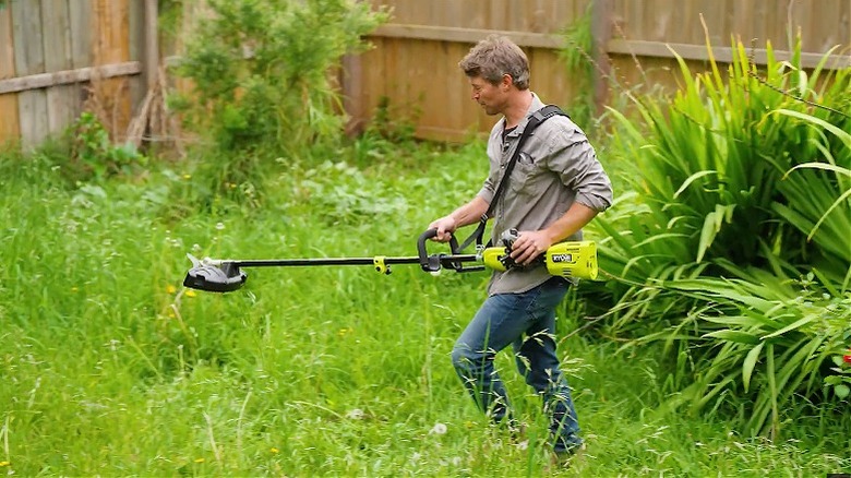 Man about to use Ryobi brush cutter