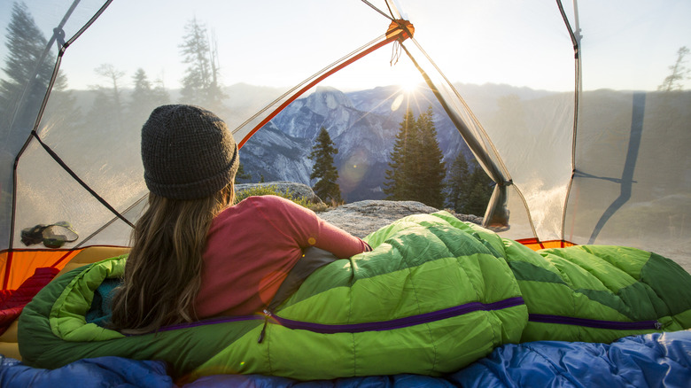 Woman lying inside of tent