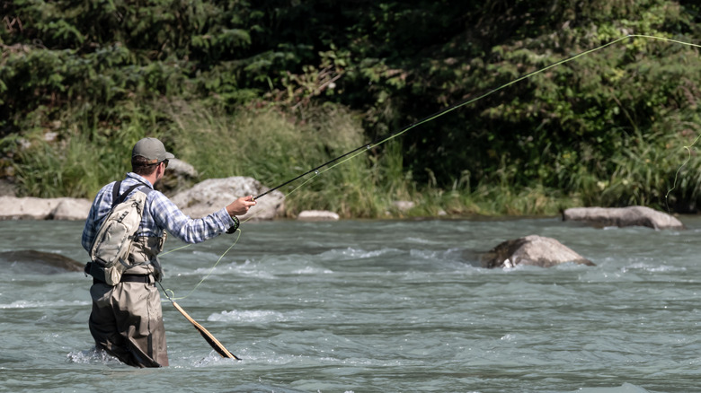 A man fly fishing in the river