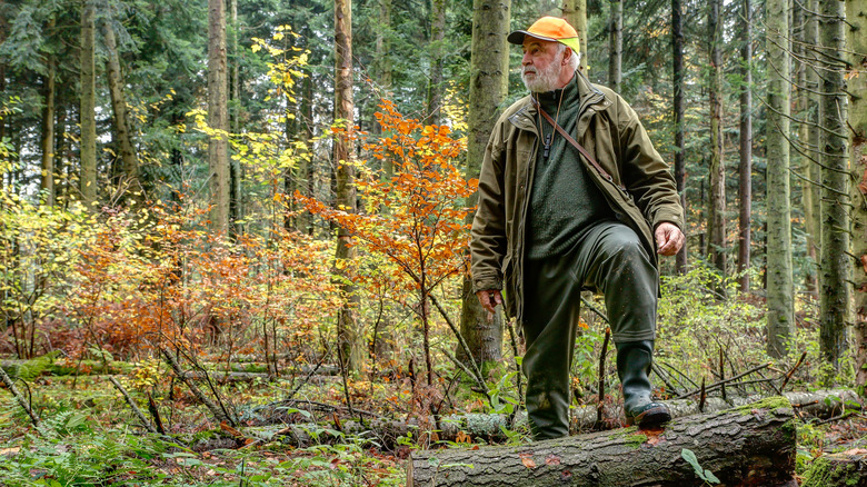 Hunter standing in the woods