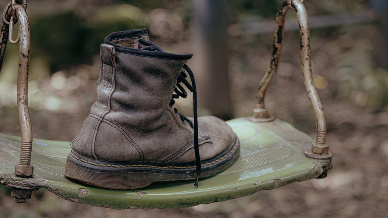 Old hiking boot on a swing