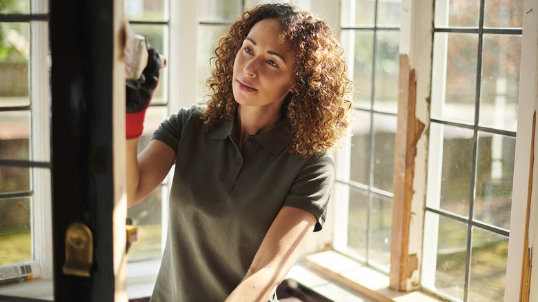 Woman paints front door