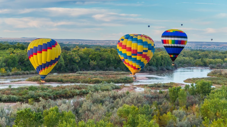 hot air balloons fly over Rio Grande in New Mexico
