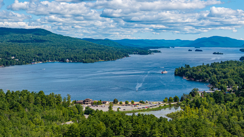 Aerial view of Lake George surrounded by forest on summer day.
