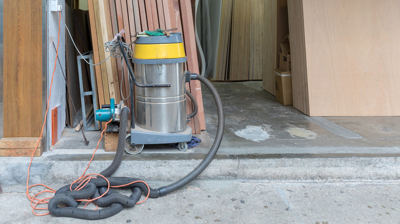 An industrial shop vacuum on the sidewalk