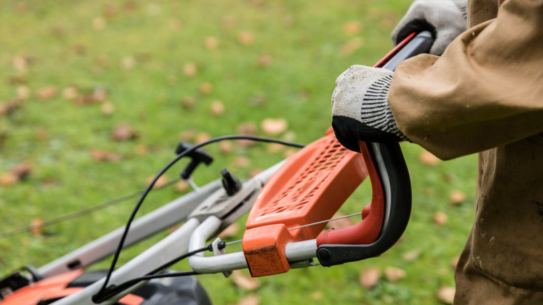 person mowing a lawn