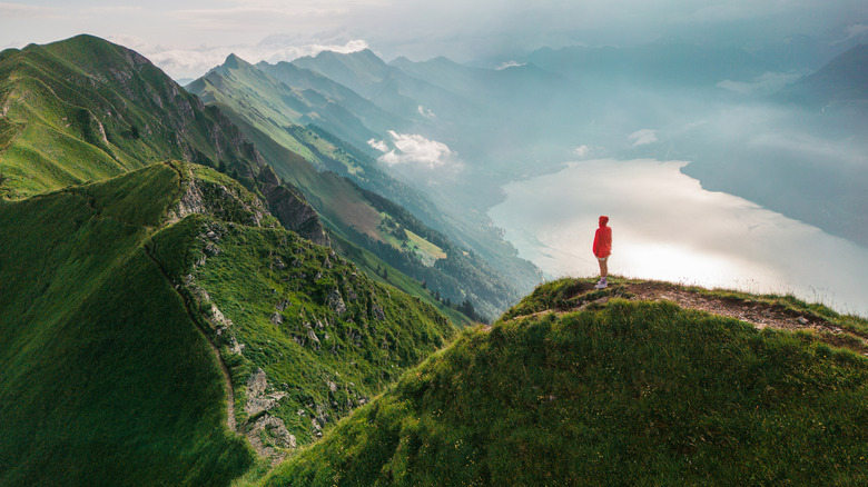 Hiker on top of steep mountain trail