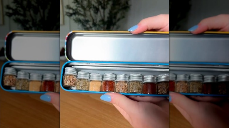 Person holding a pencil box with mini jars containing various spices