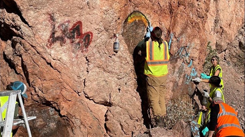 Love Lake Mead volunteers removing graffiti from rocks